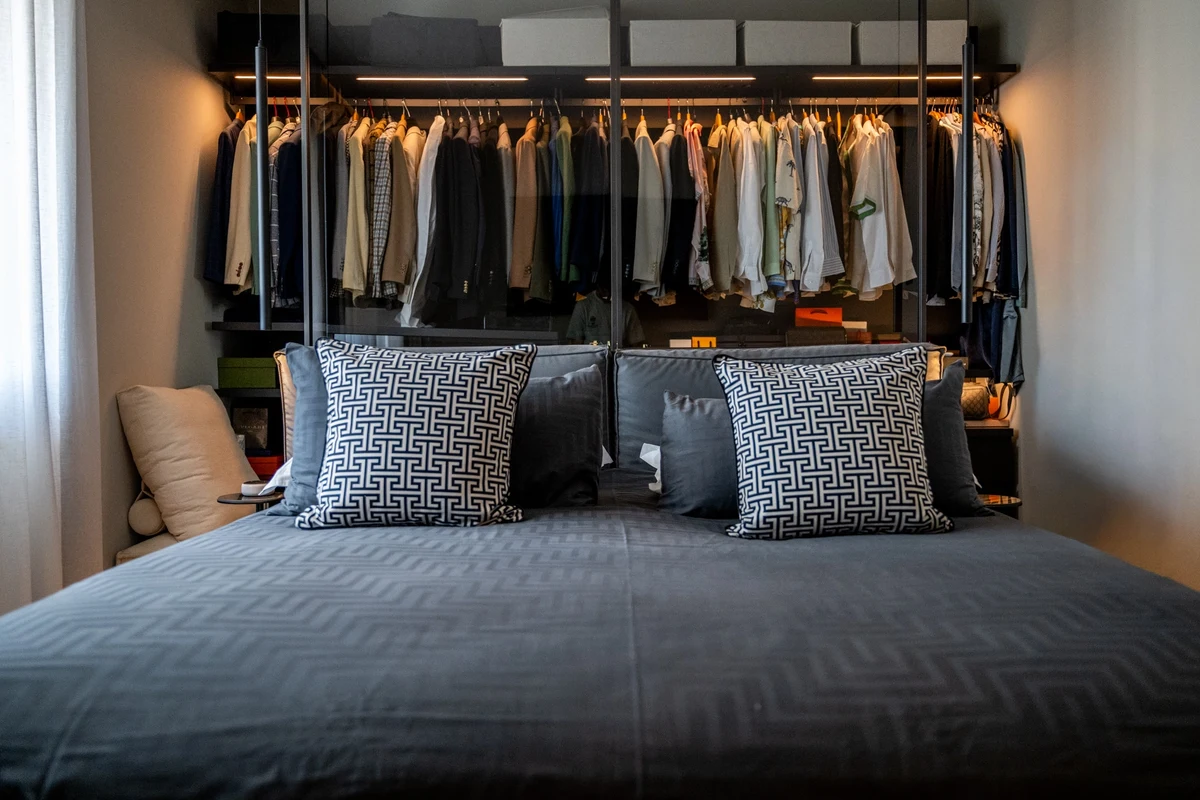 Letto in primo piano e alle spalle cabina armadio